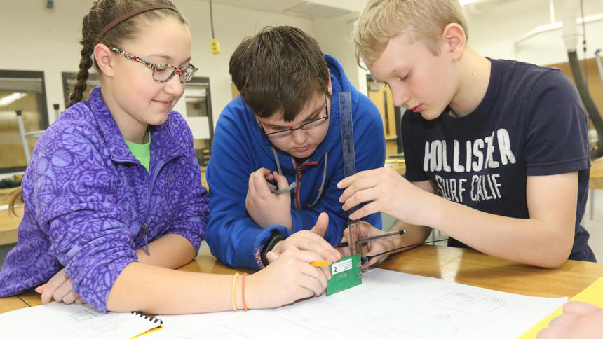 Mary working with other students on a project
